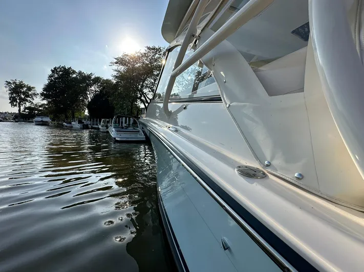 Yacht Photos Pics 2024 Grady-White Freedom 335 boat docked on a sunny day by the water.