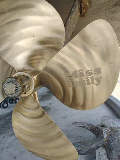 Miss Emily Yacht Photos Pics Close-up of a 1990 Broward Motor Yacht propeller with "Miss Emily" engraving.