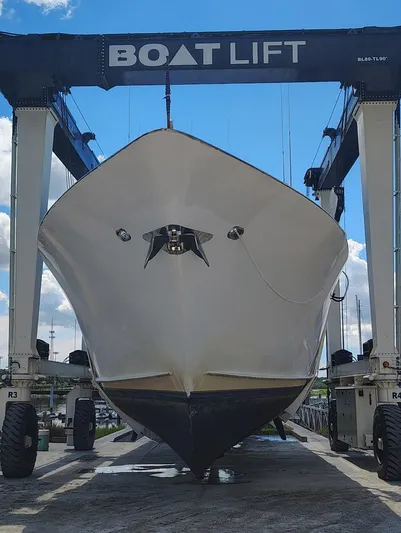 Miss Emily Yacht Photos Pics 1990 Broward Motor Yacht Extraordinaire on boat lift under blue sky.