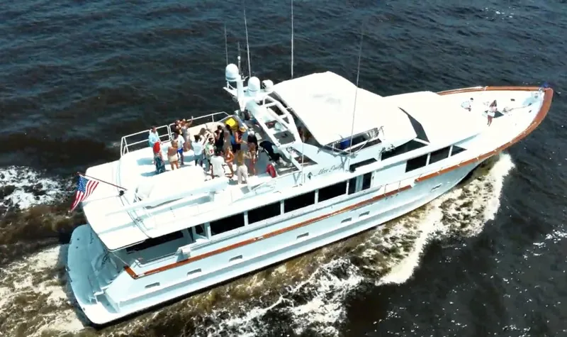 Miss Emily Yacht Photos Pics Aerial view of 1990 Broward Motor Yacht Extraordinaire cruising with passengers on deck.
