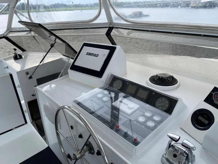 Miss Emily Yacht Photos Pics Control panel of 1990 Broward Motor Yacht Extraordinaire with Simrad navigation system.