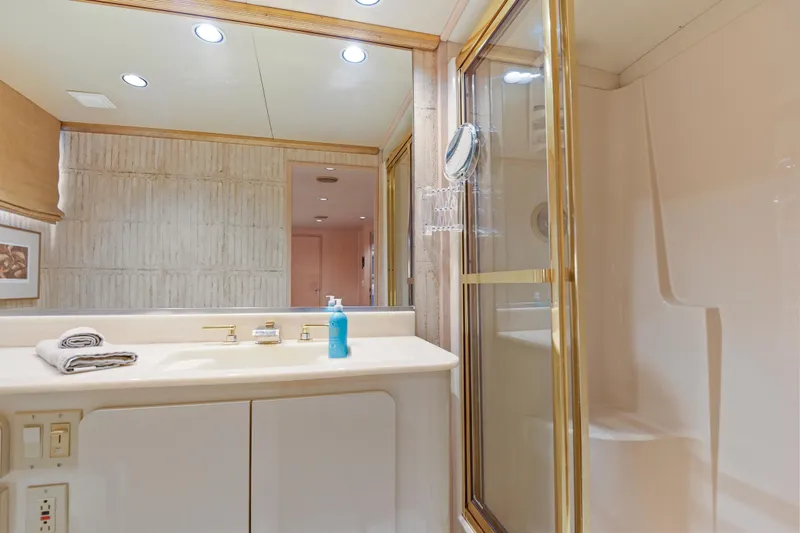 Miss Emily Yacht Photos Pics Luxurious bathroom in 1990 Broward Motor Yacht Extraordinaire with shower and vanity.