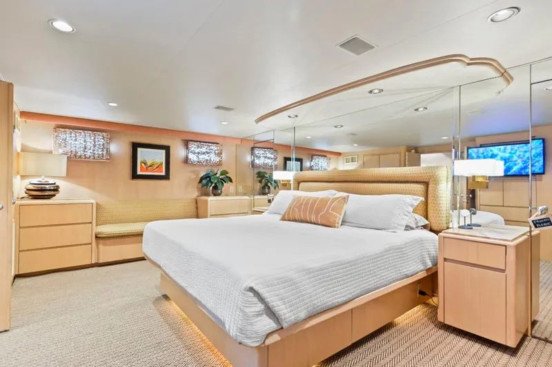 Miss Emily Yacht Photos Pics Luxurious bedroom in 1990 Broward Motor Yacht Extraordinaire, featuring elegant decor and modern amenities.