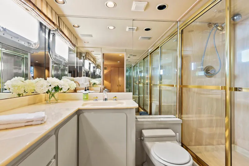 Miss Emily Yacht Photos Pics Luxurious bathroom in 1990 Broward Motor Yacht Extraordinaire with gold accents and elegant decor.