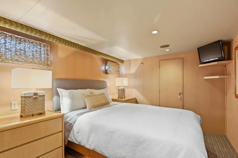 Miss Emily Yacht Photos Pics Luxurious bedroom in 1990 Broward Motor Yacht Extraordinaire with modern decor and cozy ambiance.
