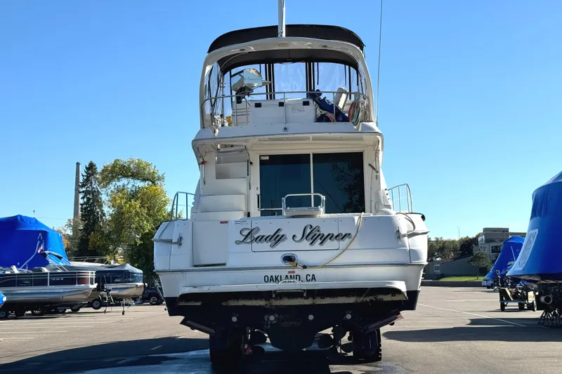 Lady Slipper Yacht Photos Pics 1996 Sea Ray 400 Sedan Bridge yacht on land, rear view, sunny day.