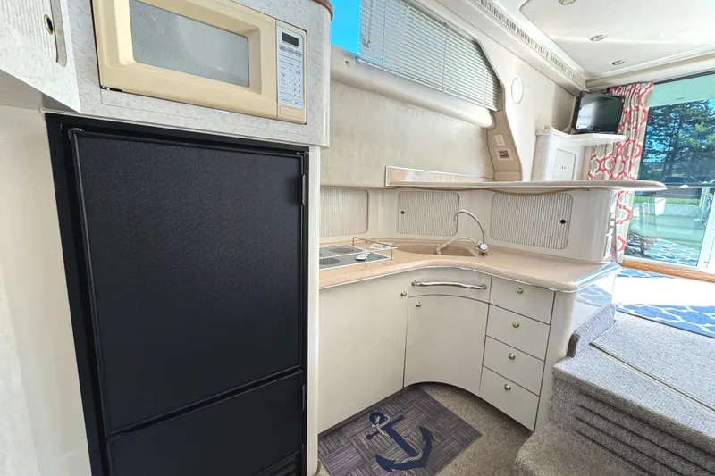 Lady Slipper Yacht Photos Pics Interior of 1996 Sea Ray 400 Sedan Bridge yacht kitchen with microwave and fridge.
