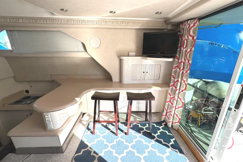 Lady Slipper Yacht Photos Pics Interior of 1996 Sea Ray 400 Sedan Bridge with modern kitchen and seating area.