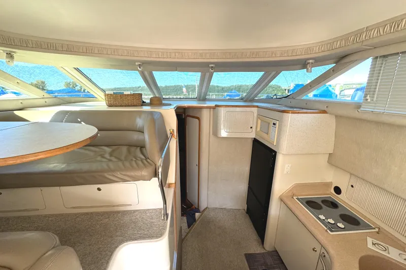 Lady Slipper Yacht Photos Pics Interior of 1996 Sea Ray 400 Sedan Bridge with kitchen and seating area.