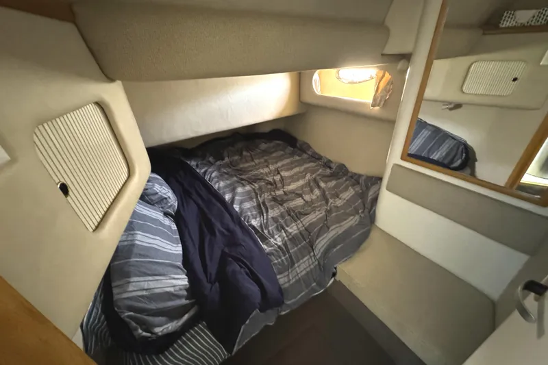 Lady Slipper Yacht Photos Pics Cozy cabin interior of 1996 Sea Ray 400 Sedan Bridge with striped bedding.