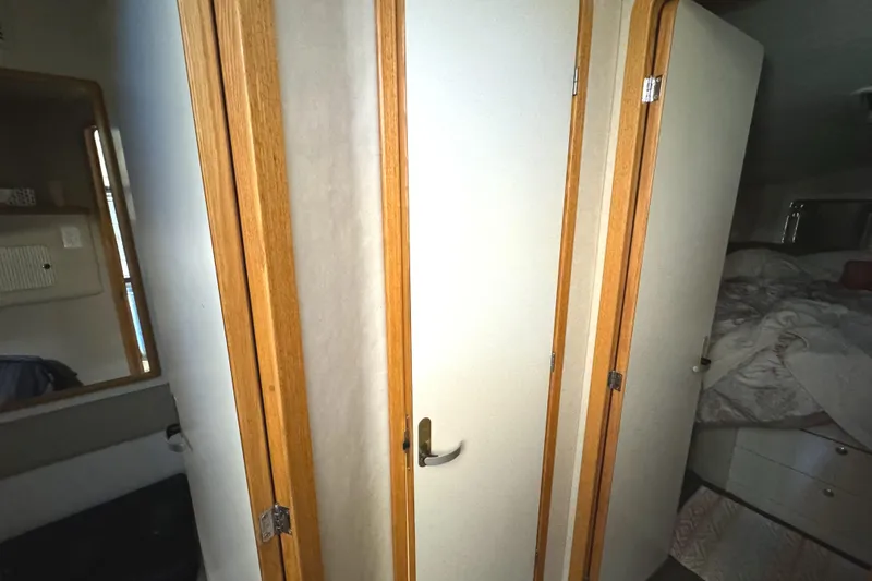 Lady Slipper Yacht Photos Pics Interior of 1996 Sea Ray 400 Sedan Bridge with wooden doors and cozy cabin space.