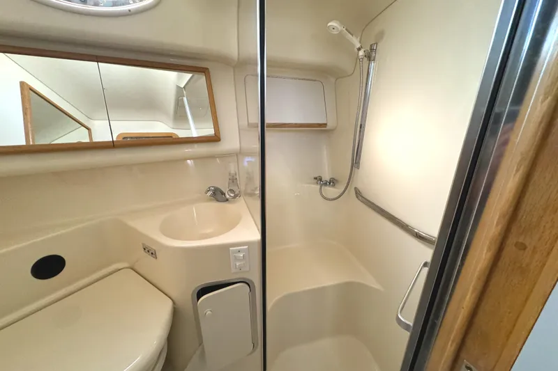 Lady Slipper Yacht Photos Pics Bathroom interior of 1996 Sea Ray 400 Sedan Bridge yacht, featuring shower and sink.