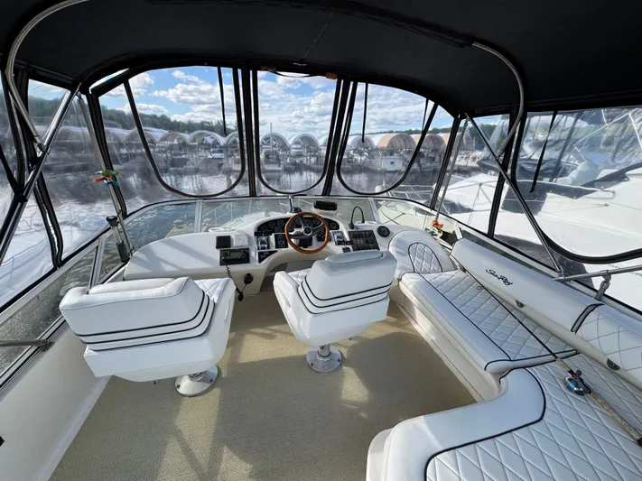 Lady Slipper Yacht Photos Pics 1996 Sea Ray 400 Sedan Bridge interior with white seating and panoramic windows.