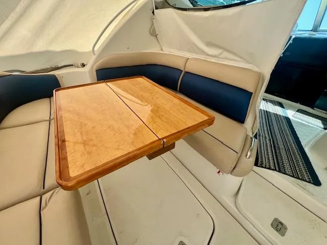  Yacht Photos Pics 2007 Tiara Yachts 3900 Sovran interior with wooden table and cushioned seating.