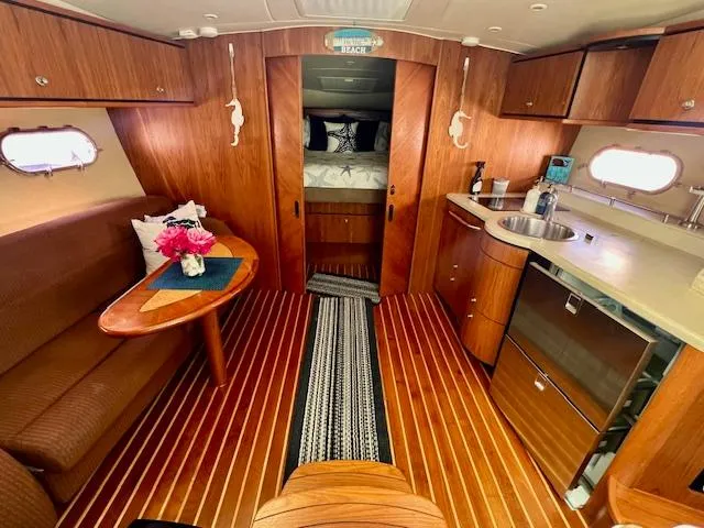  Yacht Photos Pics 2007 Tiara Yachts 3900 Sovran interior with wood finish, kitchenette, and cozy seating area.