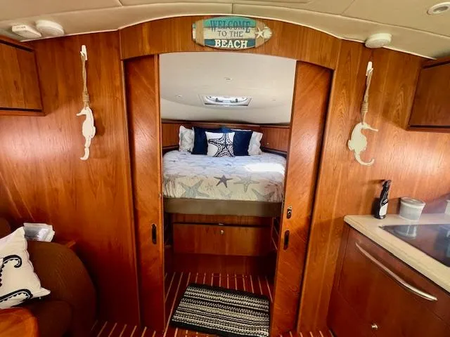  Yacht Photos Pics 2007 Tiara Yachts 3900 Sovran cabin interior with cozy bed and nautical decor.