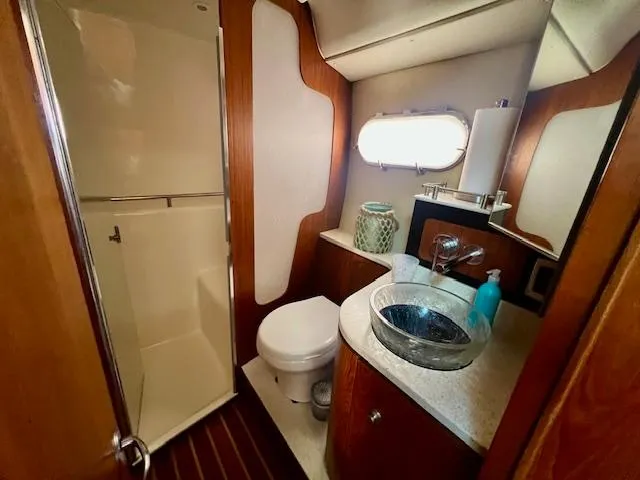  Yacht Photos Pics Luxurious bathroom in 2007 Tiara Yachts 3900 Sovran with modern fixtures and wood accents.
