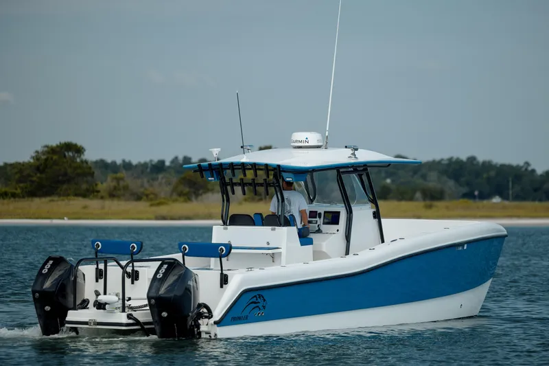  Yacht Photos Pics 2020 Prowler 31 boat with dual outboard motors cruising on calm water.