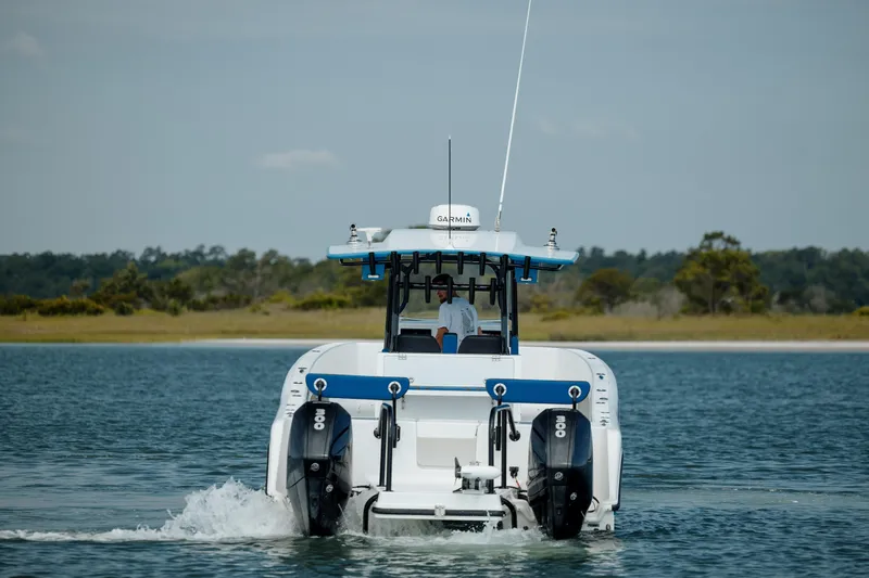  Yacht Photos Pics 2020 Prowler 31 boat cruising on water with twin engines, scenic background.