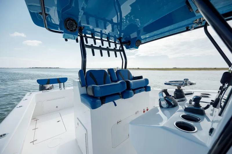 Yacht Photos Pics 2020 Prowler 31 boat interior with blue seating and control panel on open water.