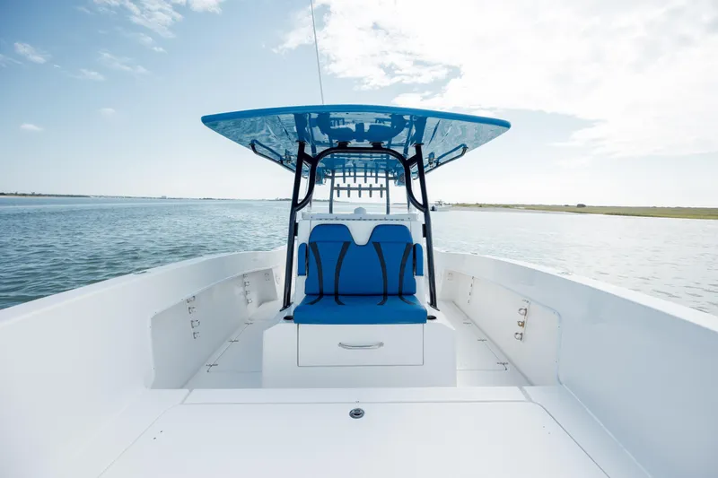  Yacht Photos Pics 2020 Prowler 31 boat with blue seating and canopy on open water.