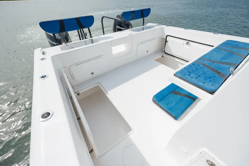  Yacht Photos Pics 2020 Prowler 31 boat deck with blue seating, spacious layout, and dual engines.