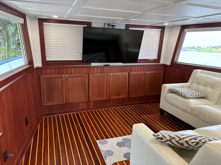 Restless T Yacht Photos Pics Luxurious 1971 Sermons Expedition yacht interior with wood paneling, TV, and leather seating.