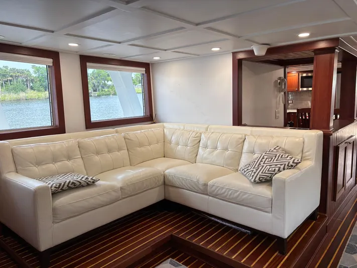 Restless T Yacht Photos Pics Luxurious 1971 Sermons Expedition yacht interior with white leather sectional and scenic windows.