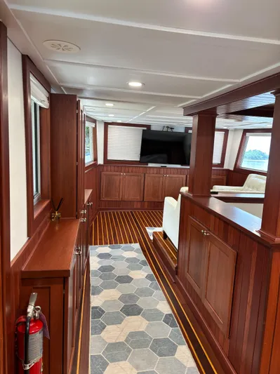 Restless T Yacht Photos Pics Interior of 1971 Sermons Expedition boat with wood paneling and hexagonal floor tiles.