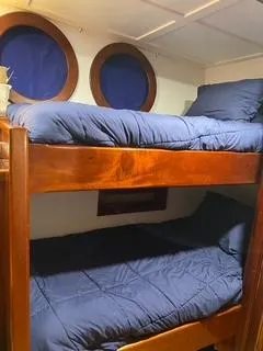 Restless T Yacht Photos Pics Bunk beds with blue bedding in a 1971 Sermons Expedition boat cabin.