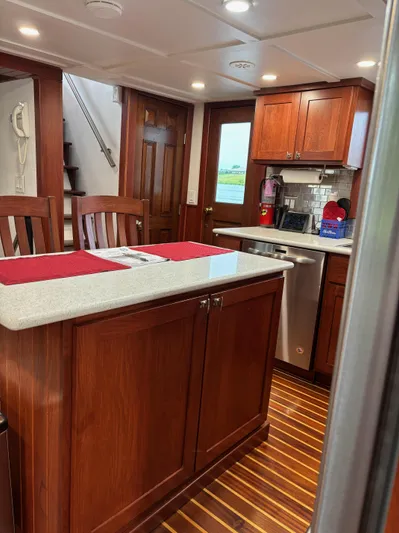 Restless T Yacht Photos Pics 1971 Sermons Expedition yacht kitchen with wooden cabinets and modern appliances.