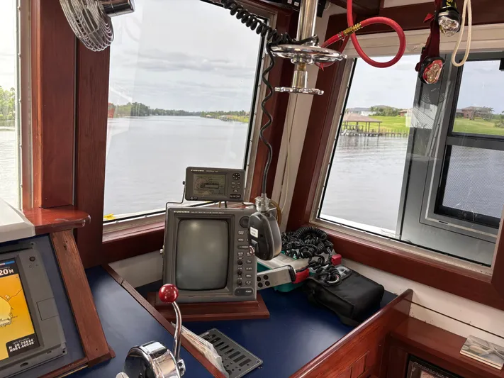 Restless T Yacht Photos Pics 1971 Sermons Expedition boat cockpit with vintage navigation equipment and river view.