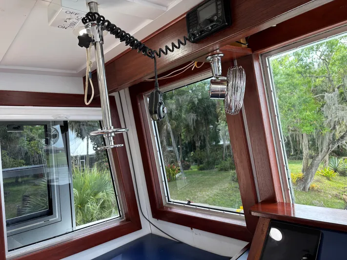 Restless T Yacht Photos Pics Interior of a 1971 Sermons Expedition boat with wooden trim and navigational equipment.