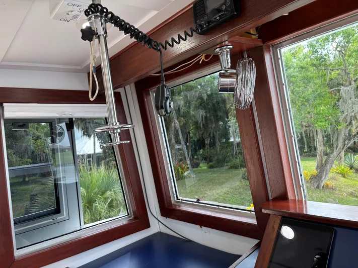 Restless T Yacht Photos Pics Interior of a 1971 Sermons Expedition boat with windows and communication equipment.