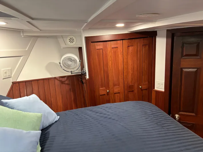 Restless T Yacht Photos Pics Cozy 1971 Sermons Expedition cabin with wood paneling, bed, and closet.