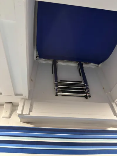 Restless T Yacht Photos Pics Foldable ladder in a 1971 Sermons Expedition boat, stored in a compact compartment.