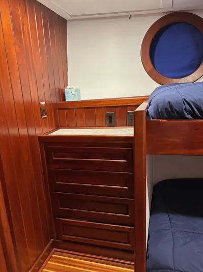 Restless T Yacht Photos Pics Wood-paneled cabin interior with bunk bed and porthole, Sermons Expedition 1971.