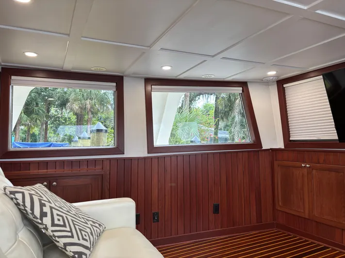 Restless T Yacht Photos Pics Interior of 1971 Sermons Expedition boat with wood paneling and large windows.