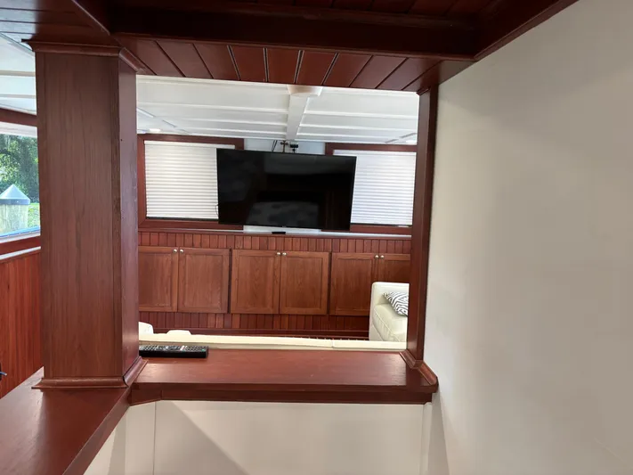 Restless T Yacht Photos Pics Interior of 1971 Sermons Expedition boat with wood paneling and TV.