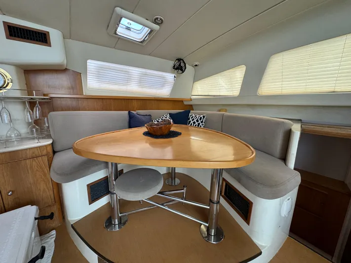 U Turn Yacht Photos Pics Cozy dining area in 2003 Leopard 47 yacht with modern furnishings and natural light.