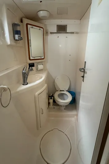 U Turn Yacht Photos Pics 2003 Leopard 47 yacht bathroom with sink, mirror, and toilet.