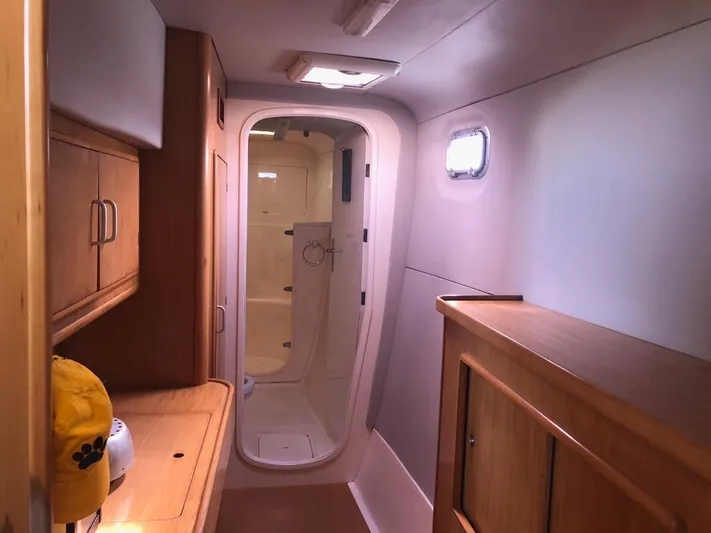 U Turn Yacht Photos Pics Interior of 2003 Leopard 47 yacht with wooden cabinetry and compact bathroom.