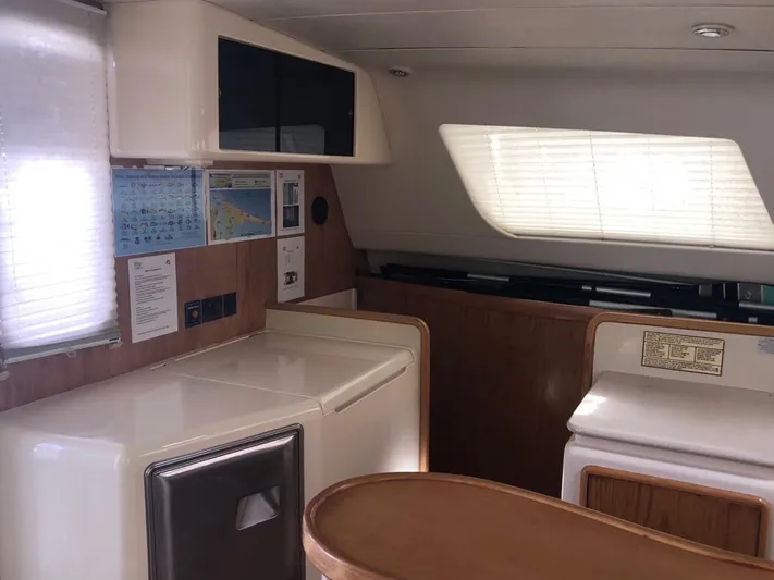 U Turn Yacht Photos Pics Interior of 2003 Leopard 47 yacht with modern kitchen and wooden accents.