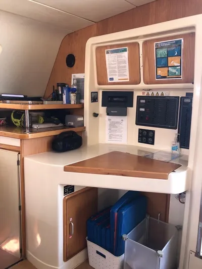 U Turn Yacht Photos Pics 2003 Leopard 47 yacht interior navigation station with control panels and storage.