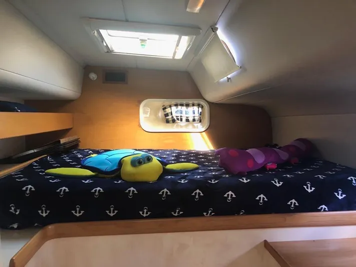 U Turn Yacht Photos Pics Cozy cabin interior of 2003 Leopard 47 yacht with plush toys and nautical bedding.