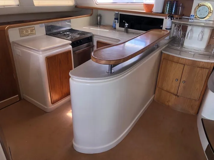 U Turn Yacht Photos Pics Luxurious kitchen interior of 2003 Leopard 47 yacht with modern amenities.