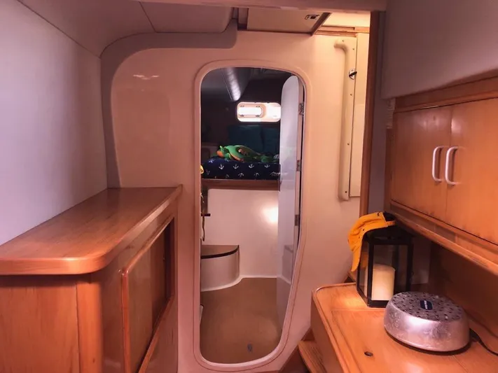 U Turn Yacht Photos Pics Interior of 2003 Leopard 47 yacht, featuring wooden cabinetry and cozy sleeping area.