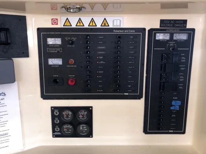 U Turn Yacht Photos Pics Electrical control panel on a 2003 Leopard 47 yacht with warning labels and gauges.