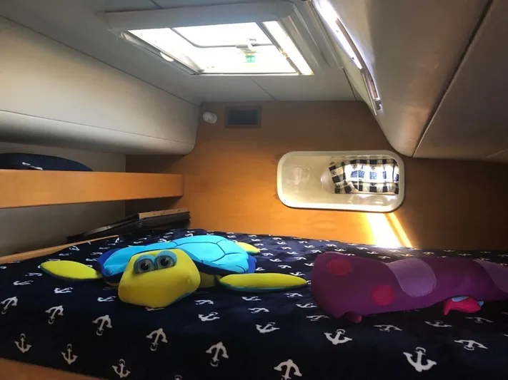 U Turn Yacht Photos Pics Cozy cabin interior of 2003 Leopard 47 yacht with plush toys on bed.