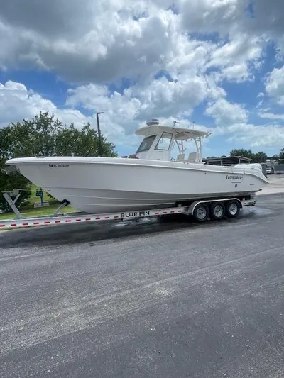  Yacht Photos Pics 2014 Everglades 325 Center Console boat on a Blue Fin trailer, parked outdoors.